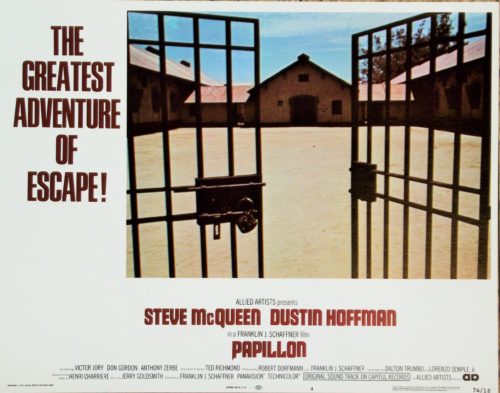 Original vintage US cinema Lobby Card for 1973 hit movie, Papillon, starring Steve McQueen and Dustin Hoffman, measuring 11 ins by 14 ins
